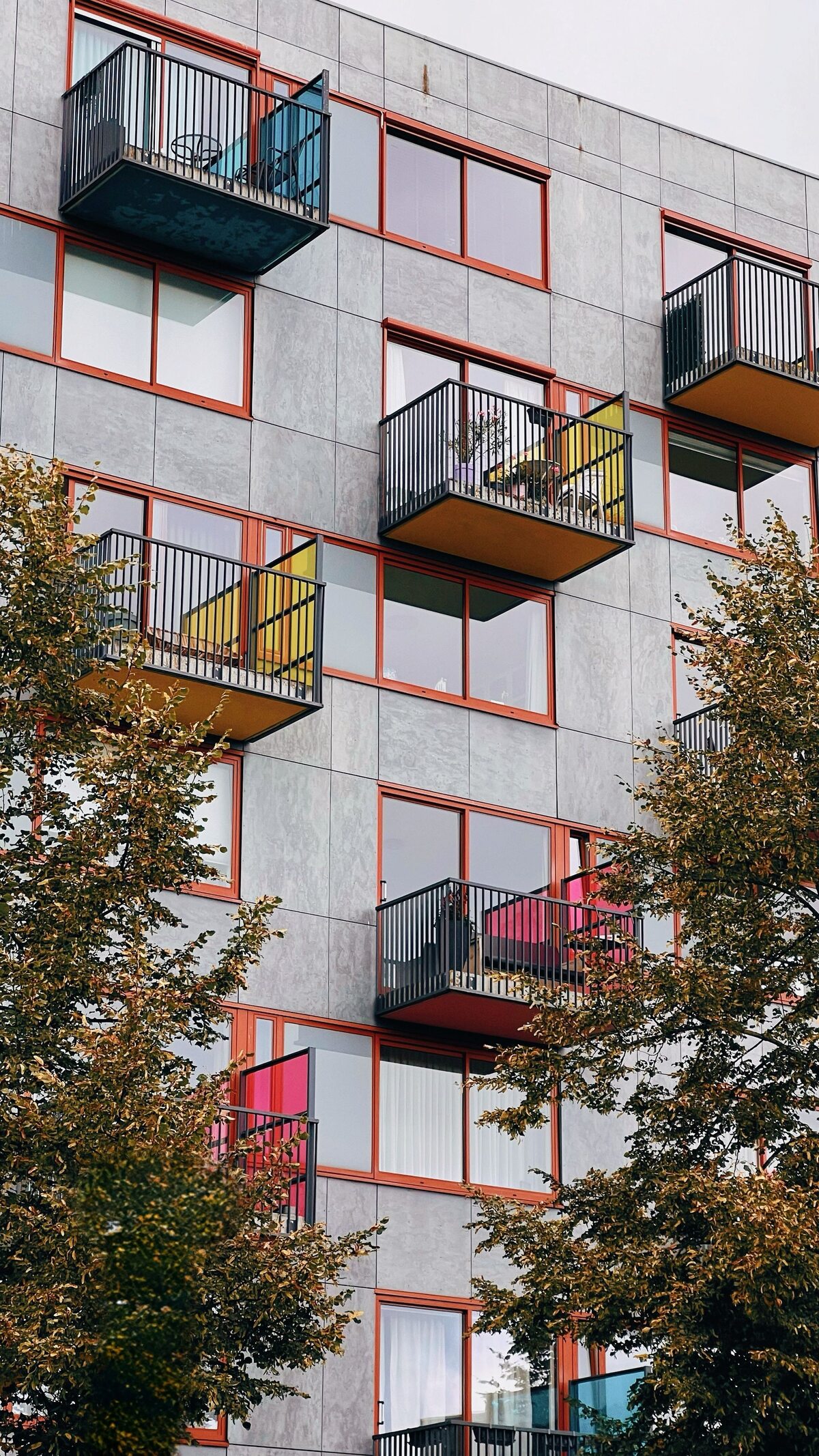 Apartment building with balconies and colourful glass privacy screens